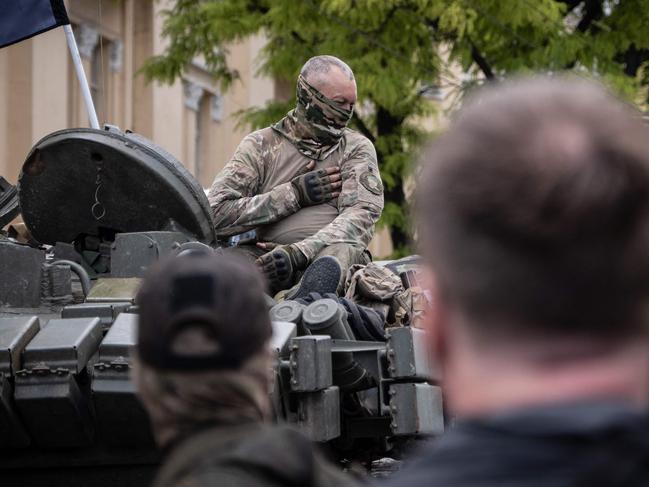 A member of Wagner group gestures as he sits atop of a tank in a street in the city of Rostov-on-Don, on June 24. Picture: Roman ROMOKHOV / AFP