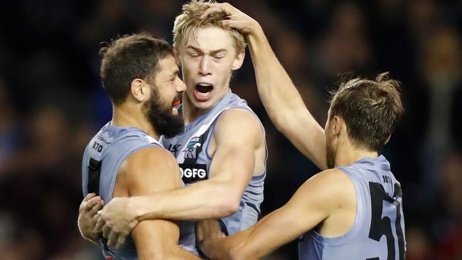 HOLLER FOR A MARSHALL: Todd Marshall (centre) is congratulated by Port Adelaide teammates Paddy Ryder (left) and Cam Sutcliffe after kicking a goal in the 59-point win against Essendon on Saturday. Picture: MICHAEL WILLSON (AFL Photos via Getty Images).