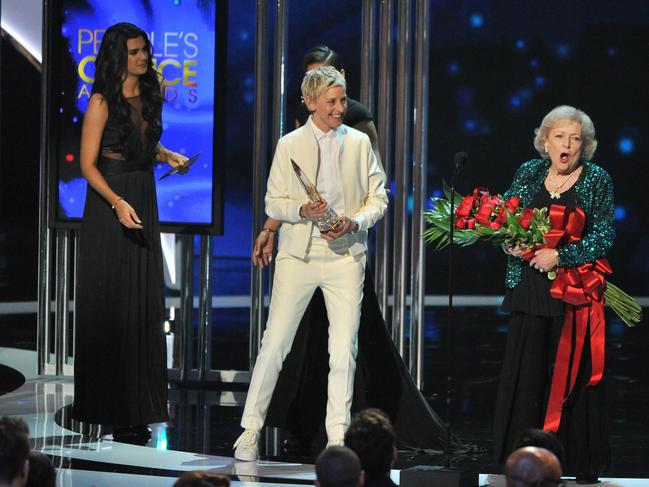 Ellen DeGeneres presents actress Betty White with the People's Choice Award for Favourite TV Icon onstage at the 41st Annual People's Choice Awards, January 7, 2015 in Los Angeles. Picture: Allen Berezovsky/WireImage