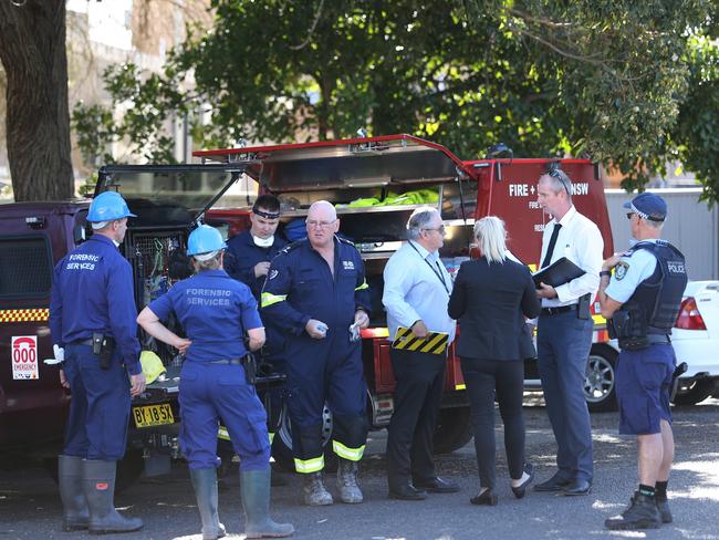 Forensics and fire investigation crews arrive at the scene of the arcade fire at The Entrance which killed a man trapped inside. Picture: Peter Lorimer.