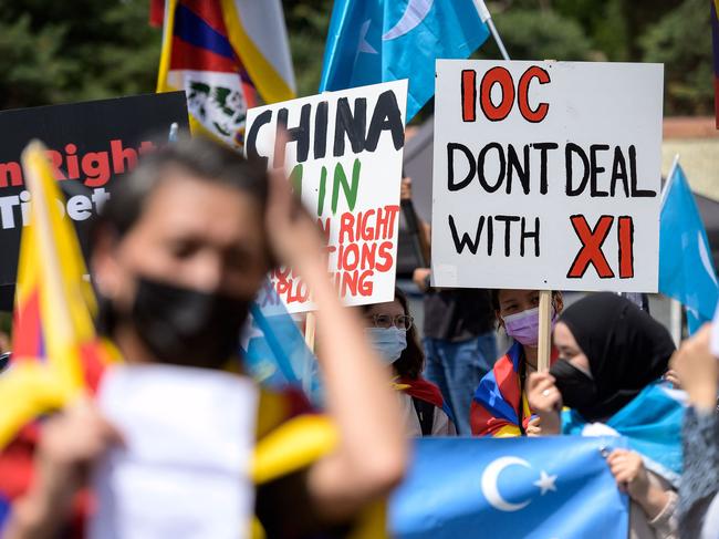 Tibetan and Uyghur activists hold placards and flags during a protest this week against the Beijing 2022 Winter Olympics. Picture: AFP