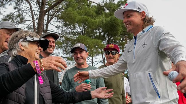 Cam Smith hugs spectator Annette Blake after his wayward tee shot on the 17th hole, hit her (Photo by Asanka Ratnayake/Getty Images)