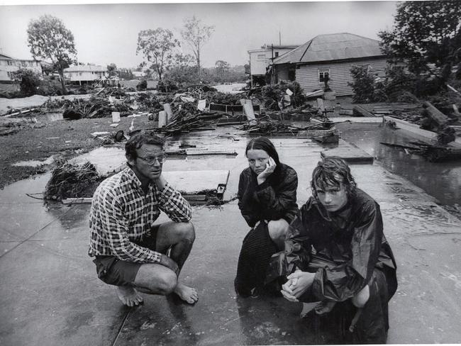 Tony Hancock and two of his 7 children, Andrea 17, and Allan 16, at the foundations of their Dixon Street , Ashgrove, house which disintegrated and was swept away by flooded Enoggera Creek.