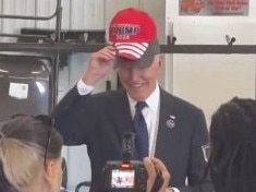 Joe Biden wears a Trump hat during a visit to a fire station. Picture: X