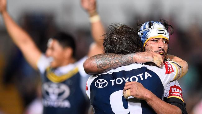 Johnathan Thurston celebrates with teammates after beating the Sharks.