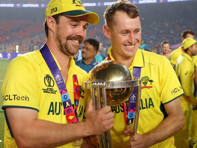 AHMEDABAD, INDIA - NOVEMBER 19: Travis Head and Marnus Labuschagne of Australia poses with the ICC Men's Cricket World Cup Trophy following the ICC Men's Cricket World Cup India 2023 Final between India and Australia at Narendra Modi Stadium on November 19, 2023 in Ahmedabad, India. (Photo by Robert Cianflone/Getty Images)