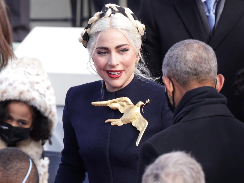 Lady Gaga greets Barack Obama after singing the National Anthem. Picture: Alex Wong/Getty Images