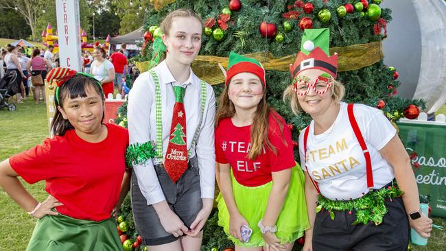 Raphaella Olino, Molly Robinson, Franki Carter and Jillian Dearling pose for a photograph at Caboolture Christmas Carols. (AAP Image/Richard Walker)