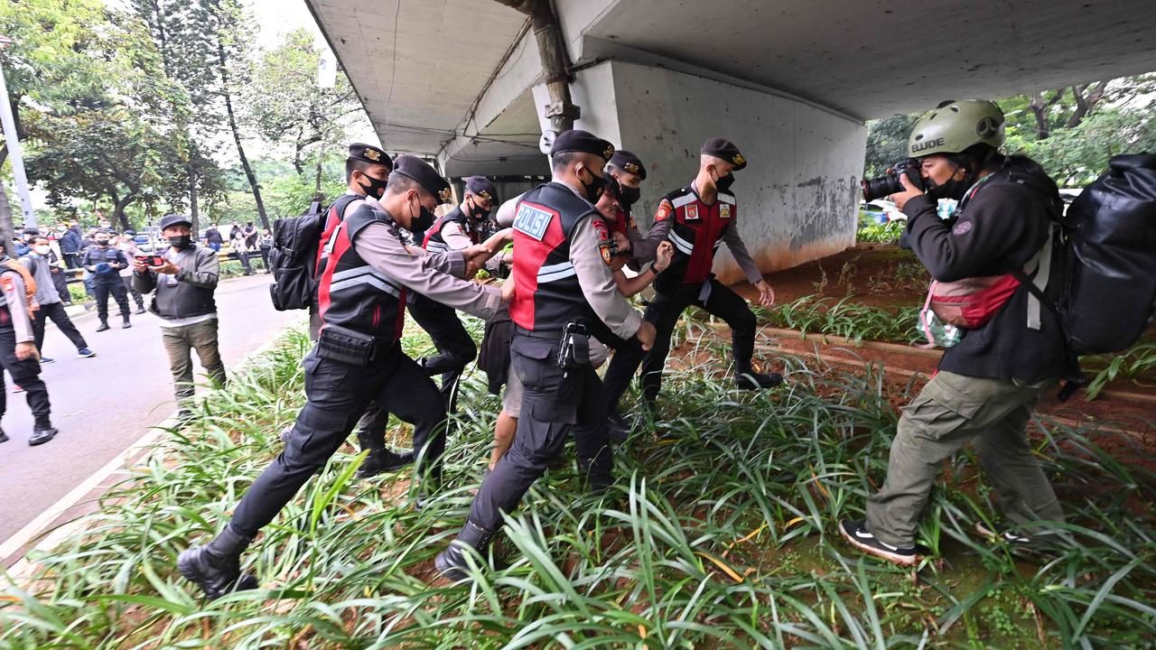 Police arrest a man/ Picture: ADEK BERRY / AFP