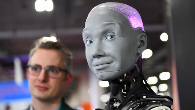 Morgan Roe, director of operations at Engineered Arts, speaks about the Engineered Arts Ameca humanoid robot with artificial intelligence as it is demonstrated during the Consumer Electronics Show in Las Vegas. Picture: Patrick T. FALLON / AFP