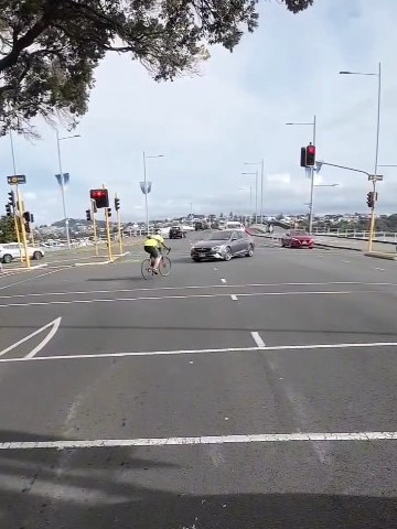 A video posted by a New Zealand motorcycling influencer showed a cyclist running a red light and swerving to avoid a car. Instagram/ NZ Outlaw