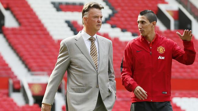 Manchester United's new player Angel Di Maria lright, and manager Louis van Gaal, pose for photographers, at Old Trafford Stadium in Manchester, England, Thursday, Aug. 28, 2014. Manchester United have signed winger Angel Di Maria from Real Madrid for a British record transfer fee of £59.7m. The Argentine winger had a medical in Manchester on Tuesday and has signed a five-year deal. (AP Photo/Alastair Grant)