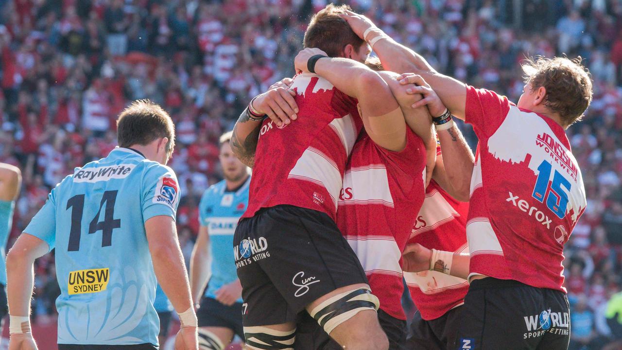 Lions players celebrate a try to Kwagga Smith. Picture: AFP