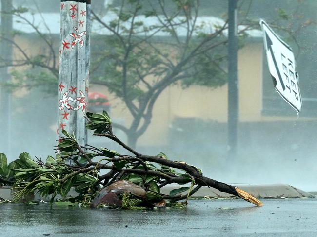 A keep left sign flies down the street after being ripped from its post in the main street of Bowen. Picture: Lyndon Mechielsen/The Australian