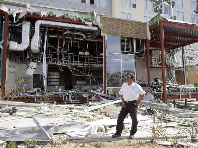 A security guard stands in front of a Hyatt hotel destroyed by the hurricane.