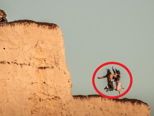 The women jumped near the clifftop.