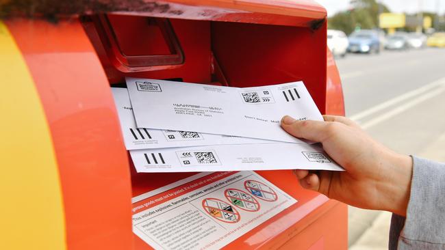 Sealed envelopes from the Marriage Law Postal Survey are seen being posted in Adelaide. Picture: AAP