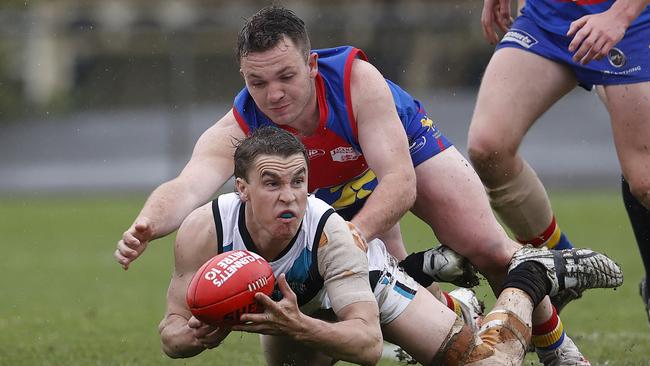 SFL grand final between Cygnet v Huonville from North Hobart Oval. Huonville's Tristan Barnett attempts to tackle Cygnet's Rhys Jennings. Picture: Zak Simmonds