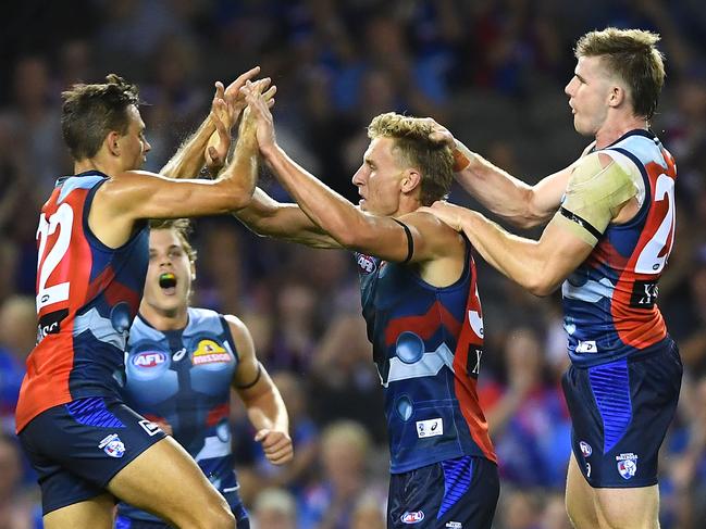 MELBOURNE, AUSTRALIA - MARCH 23: Aaron Naughton of the Bulldogs is congratulated by team mates after kicking a goal during the round one AFL match between the Western Bulldogs and the Sydney Swans at Marvel Stadium on March 23, 2019 in Melbourne, Australia. (Photo by Quinn Rooney/Getty Images)