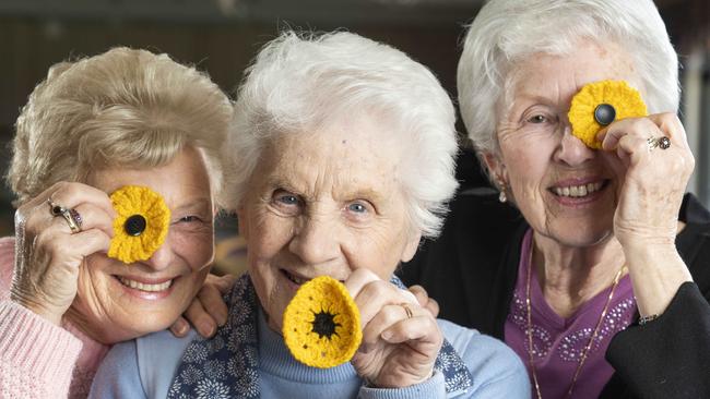 May Tilly, Dot Macarthy and Pam Lee with the poppies they’ve knitted. Picture: Matthew Vasilescu