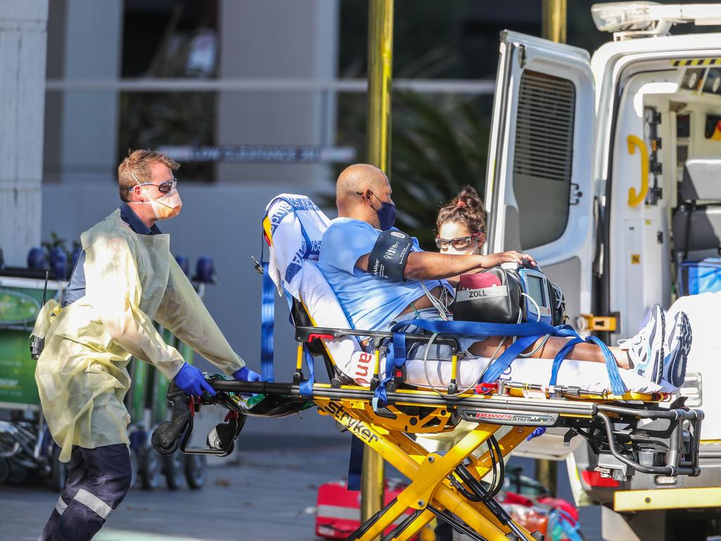 Many Australians are genuinely concerned about the coronavirus vaccine. A guest staying at The View hotel is seen being attended to by paramedics as he is stretchered into an ambulance on January 14 in Melbourne. Picture: Asanka Ratnayake/Getty Images