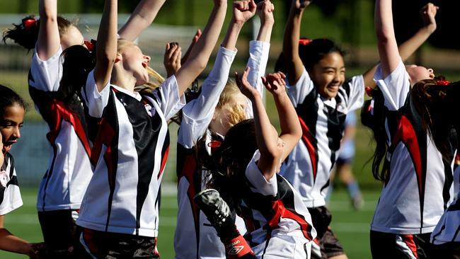 Glenwood Reds under-12 girls celebrate their 2-0 grand final over Quakers Hill at Blacktown International sports park. Pictures: Peter Kelly