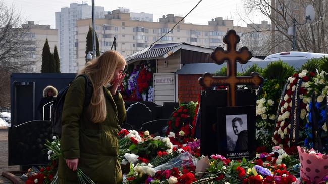 A mourner wipe a tear as she visits the grave of Alexei Navalny at the Borisovo cemetery in Moscow on Saturday. Picture: AFP