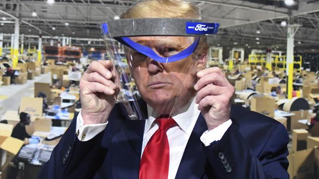 Mr Trump did, apparently, agree to pose with this face shield, which is one of the PPE items being manufactured at the plant. He’s not wearing it, but he is holding it up to his face, for some reason? Yeah. Picture: Daniel Mears/Detroit News via AP