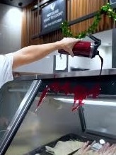 Pouring fake ‘blood’ on the window of the butcher. Picture: Instagram