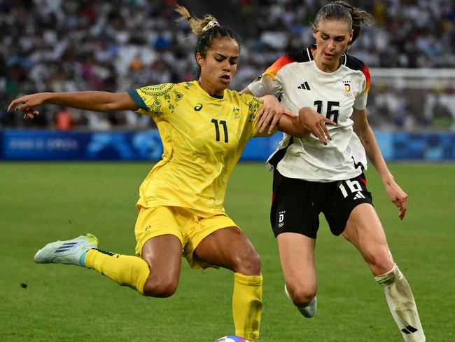 Australia's forward #11 Mary Fowler is marked by Germany's midfielder #16 Jule Brand during the women's group B football match between Germany and Australia during the Paris 2024 Olympic Games at the Marseille Stadium in Marseille on July 25, 2024. (Photo by Christophe SIMON / AFP)