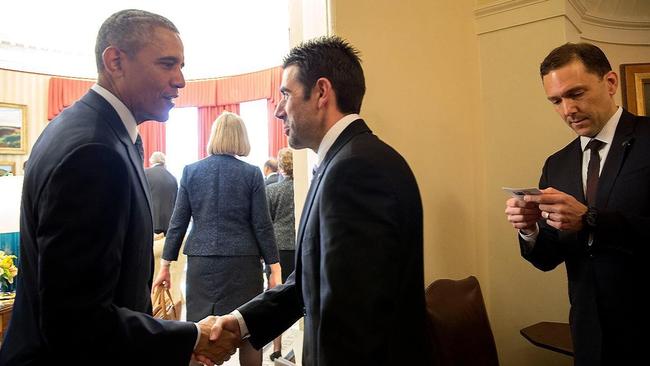 ASPI executive director Justin Bassi, centre, shakes hands with then US president Barack Obama in 2016.