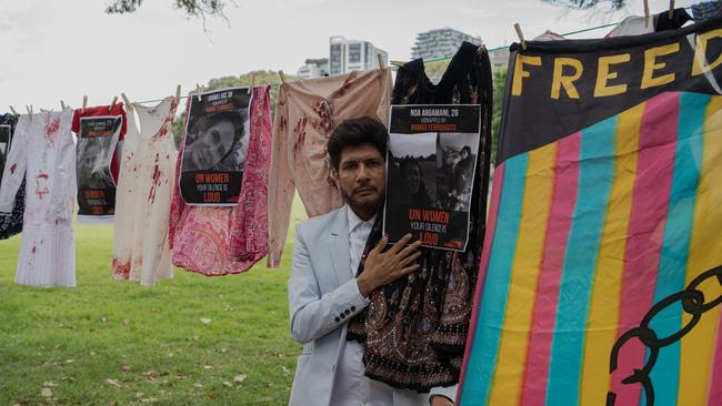 A protester poses the photo of a 26-year-old victim of the October 7 attacks. Picture: NCA NewsWire / Flavio Brancaleone