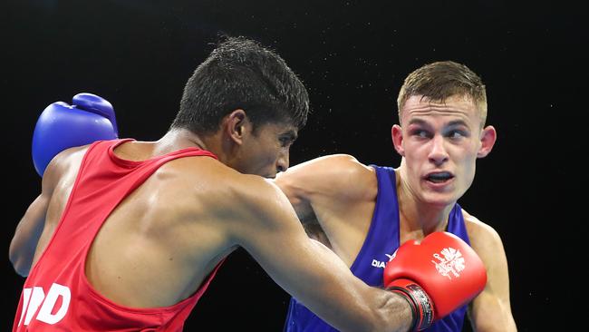 Harry Garside of Australia (Blue) on his way to gold against Manish Kausjik of India. (Photo by Chris Hyde/Getty Images)