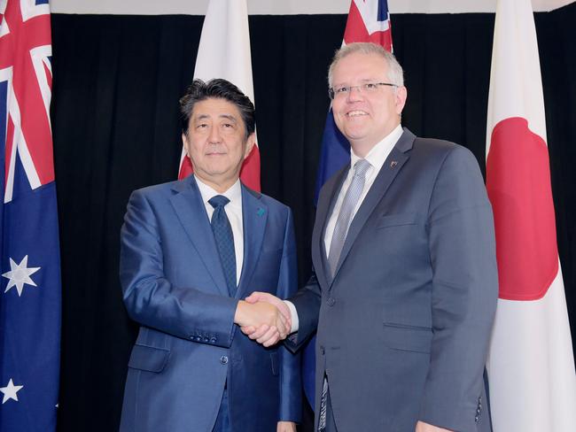 Japan's Prime Minister Shinzo Abe (L) shakes hands with Australia's Prime Minister Scott Morrison (R) during their bilateral meeting at the Northern Territory Parliament House in Darwin on November 16, 2018, on the sidelines of Abe's visit to Papua New Guinea for the Asia-Pacific Economic Cooperation (APEC) Summit. (Photo by Michael FRANCHI / POOL / AFP)