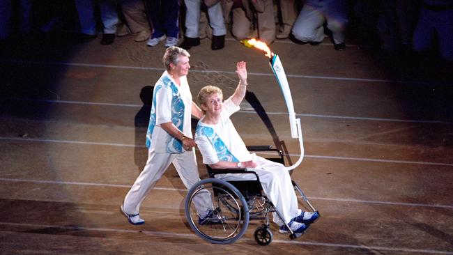 Betty Cuthbert is pushed by Raelene Boyle during the Opening Ceremony of the Sydney 2000 Olympic Games at the Olympic Stadium in Homebush Bay, Sydney, Australia. \\ Mandatory Credit. Pic: Shaun Botterill /Allsport