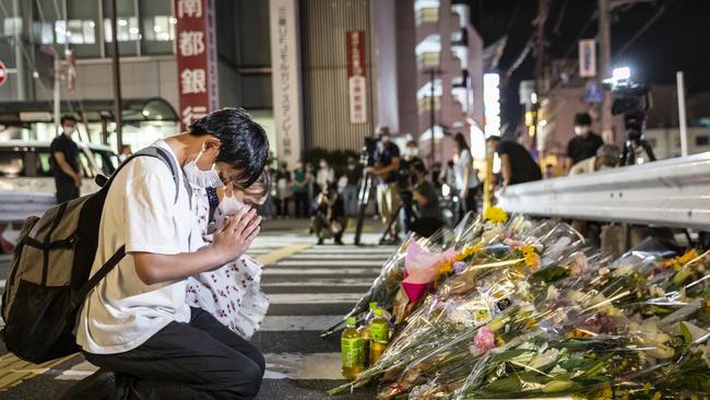 People pray at a site outside of Yamato-Saidaiji Station where Abe was shot. Picture: Yuichi Yamazaki/Getty Images