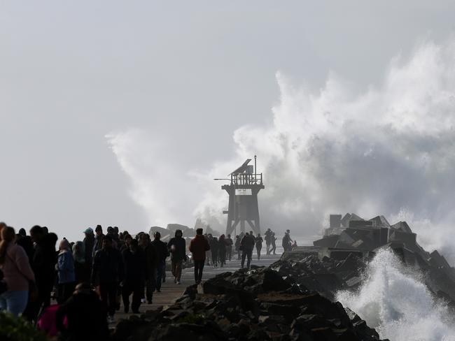 Wild seas and huge swells lash the Newcastle Coastline as hundreds of onlookers make the trek out Nobby's Breakwall to view the spectacular show. Picture by Peter Lorimer.