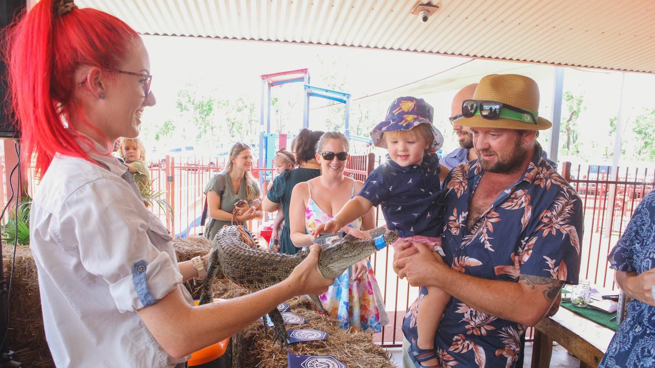 Croc racing at the Berry Springs Tavern for Melbourne Cup Day: Tom Prsa and son Luka Prsa, 2, meet a competing croc. Picture: GLENN CAMPBELL