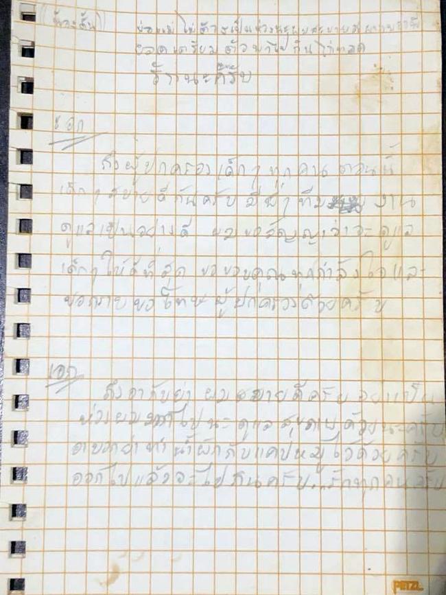 A letter written from of the boys that says: "Dad and mum, don't worry. I am fine. Please tell Brother Yod to get prepared to take me to a fried chicken shop. Love you all!" Picture: Getty