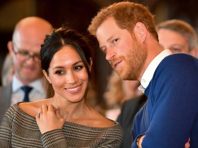 CARDIFF, WALES - JANUARY 18:  Prince Harry whispers to Meghan Markle as they watch a dance performance by Jukebox Collective in the banqueting hall during a visit to Cardiff Castle on January 18, 2018 in Cardiff, Wales. (Photo by Ben Birchall - WPA Pool / Getty Images)