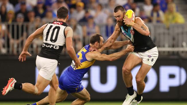 Charlie Dixon tries to break away from Eagles skipper Shannon Hurn. Picture: Paul Kane/Getty Images