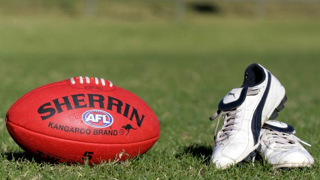 Generic AFL Sherrin football and football boots. sport /