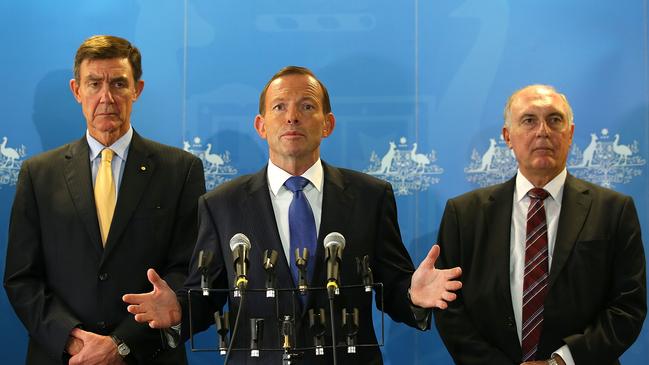 Australian Prime Minister Tony Abbott (C) addresses the media together with former Defence Force Chief Angus Houston (L) and Deputy Prime Minister Warren Truss (R) at RAAF base Pearce on March 31, 2014 in Perth, Australia. Picture: Paul Kane-Pool/Getty Images