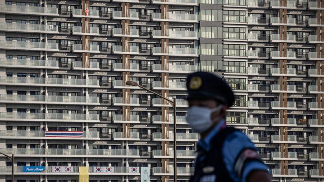 A police officer stands guard next to an accommodation building in the Tokyo Olympics athletes village. Picture: Getty Images