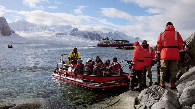 Cruise ship passengers take an Antarctic shore excursion in a zodiac.