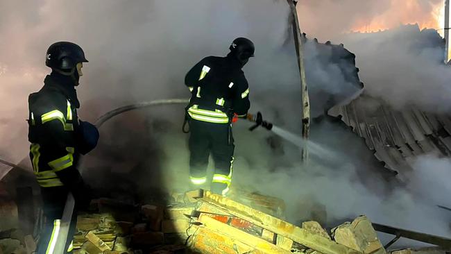 Ukrainian rescuers work to extinguish a fire at an energy infrastructure facility following a missile attack in Lutsk, Volyn region. Picture: Handout/Ukrainian Emergency Service/AFP