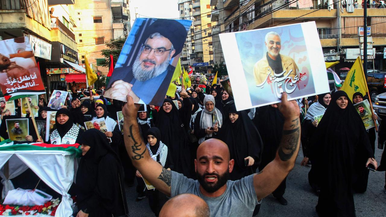 A placard depicting Hezbollah chief Hassan Nasrallah, left. Picture: Mahmoud Zayyat/AFP