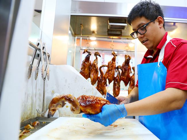 Kevin Nguyen with fresh Roasted Duck at Sunrise BBQ Butcher at Sunnybank. Picture: Lachie Millard