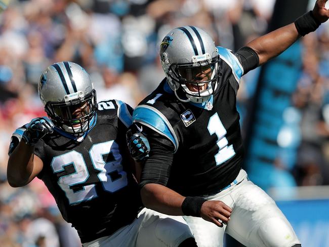 Teammates Jonathan Stewart #28 and Cam Newton #1 of the Carolina Panthers celebrate after a touchdown against the Arizona Cardinals.