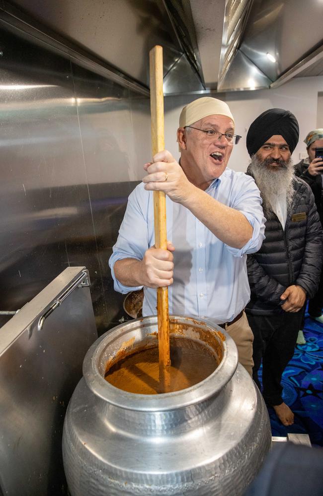 Mr Morrison joined volunteers in cooking up traditional Sikh fare. Picture: Jason Edwards